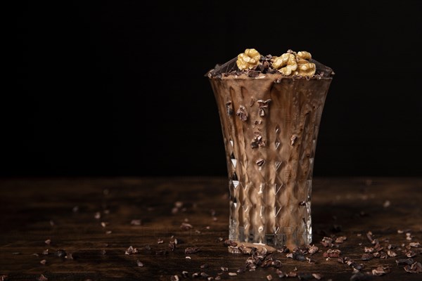 Close up view chocolate milkshake with walnuts