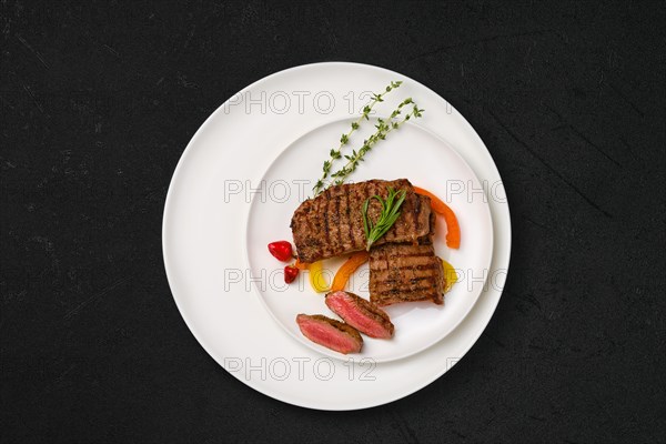 Grilled lamb steaks cut on slices on a plate