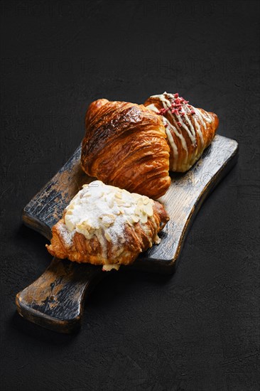 Assortment of crispy croissants on serving board