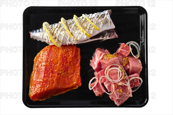 Marinated varieties of meat and fish ready for grilling isolated on white background