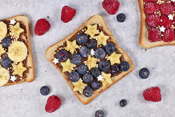 Healthy food with slices of fruit spelt toast bread topped with blueberry and banana and puffed quinoa grains