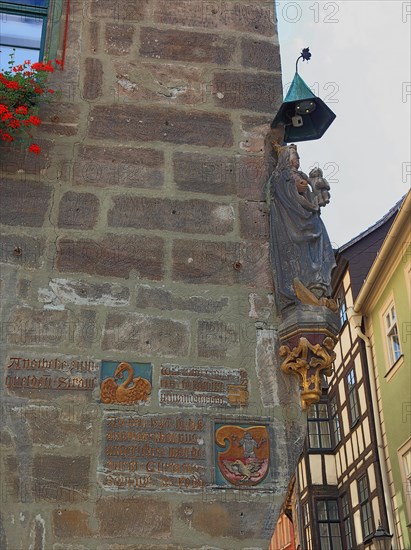 Figure of the Mother of God and a statue of St. Christopher on the house