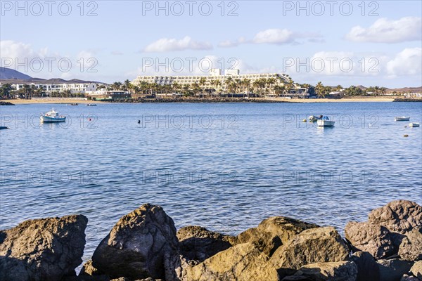 View of the resort town named Costa Teguise with boats on the foreground