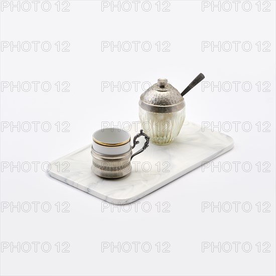 Vintage porcelain coffee cup in silver holder and sugar bowl with little spoon