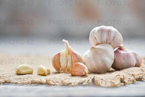 Garlic cloves and bulbs on wooden cutting board