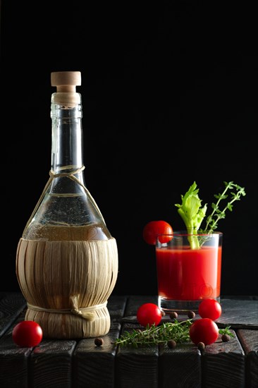 Rustic cocktail Bloody Mary with ingredient on wooden table