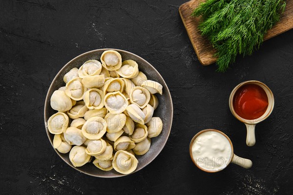 Top view of homemede meat dumplings on black background