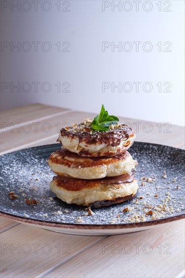 Fritters with peanut butter. Traditional Slavic pancakes with chocolate paste