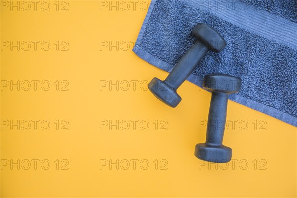 Dumbbells towel yellow background