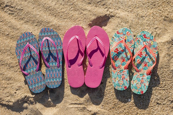 Flat lay three pairs flip flops