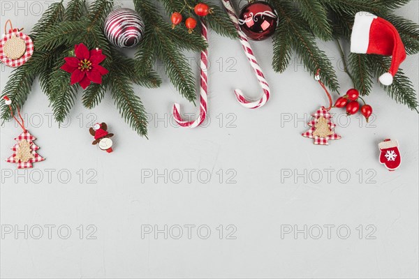 Green fir tree branches with candy canes small toys