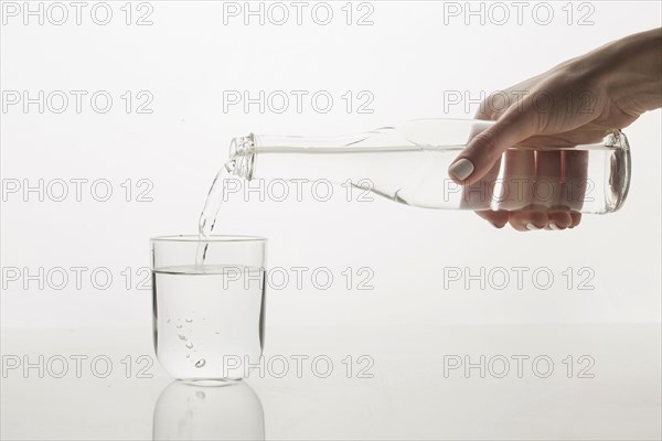 Person pouring water glass front view. Resolution and high quality beautiful photo