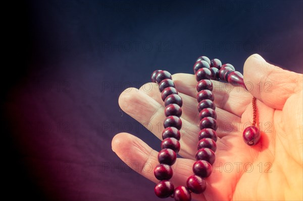 Set of some praying beads of various colors in hand