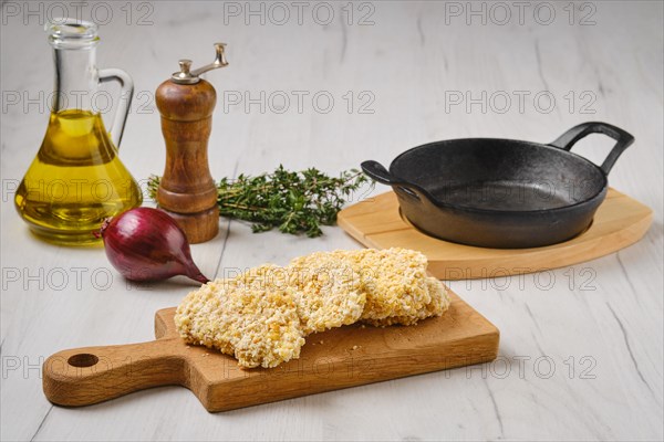 Semifinished and frozen chicken nuggets in breading ready for frying