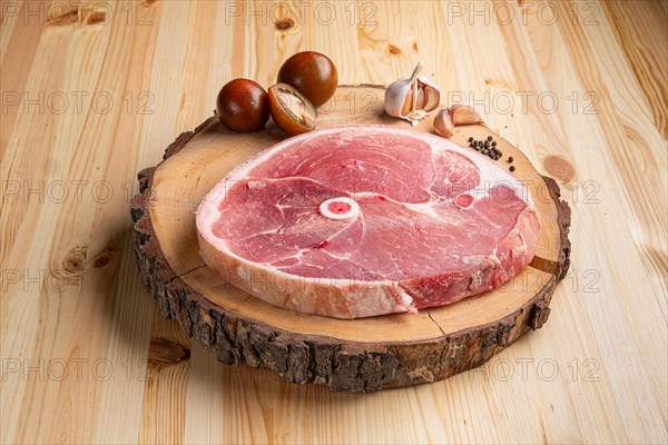Piece of fresh pork shoulder on wooden cutting board