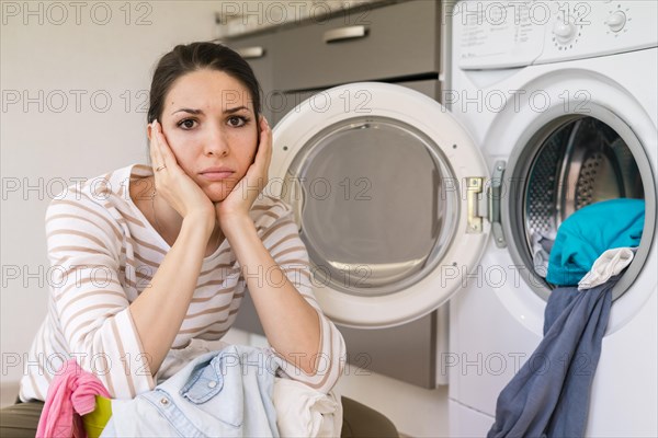 Upset woman doing laundry portrait. Resolution and high quality beautiful photo