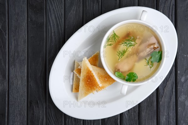 Clear beef broth with egg and toasts