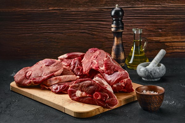 Assortment of raw fresh lamb meat on wooden tray