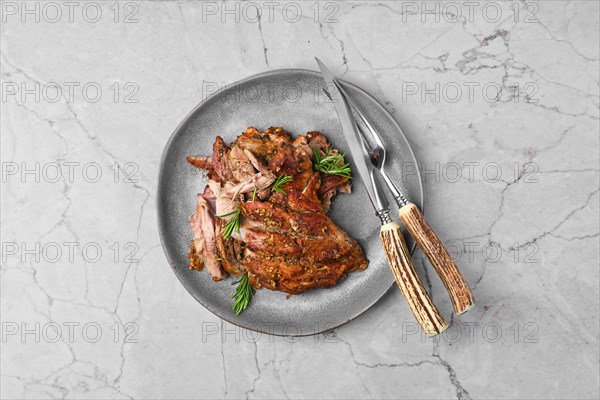 Top view of pulled lamb meat baked in oven on marble table