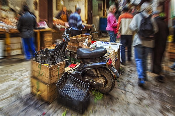 Moped parked between boxes