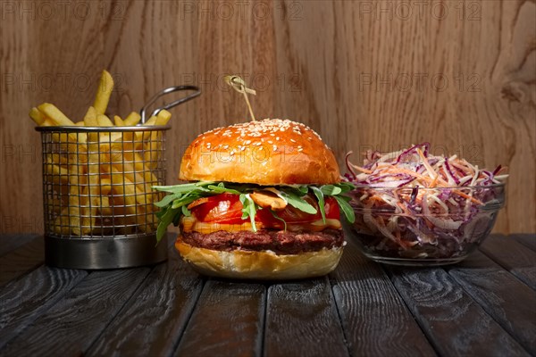 Beef burger with french fries and red cabbage salad