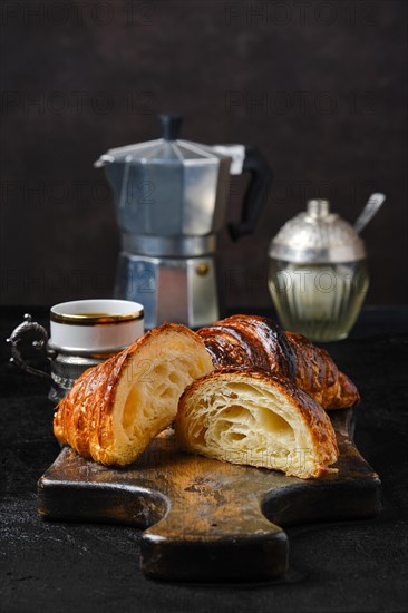 Classic breakfast with croissant cut on half and espresso coffee