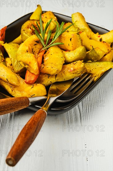 Spicy pumpkin and carrot baked in oven on ceramic plate