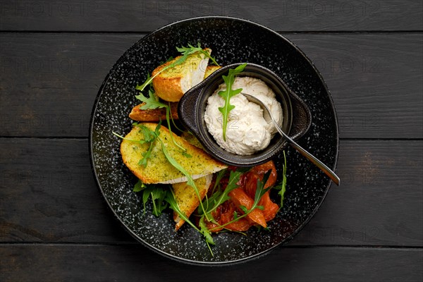 Top view of crispy toasted garlic bread with sour curd and braised tomato