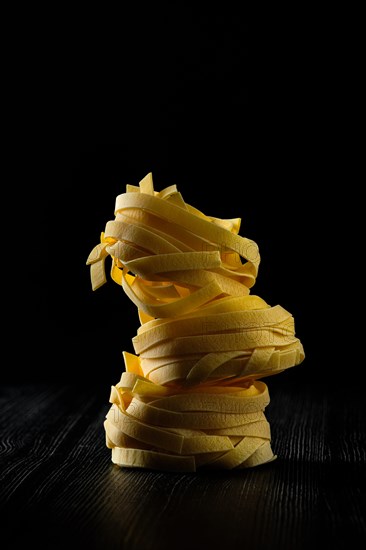 Low key photo of italian tagliatelle with egg