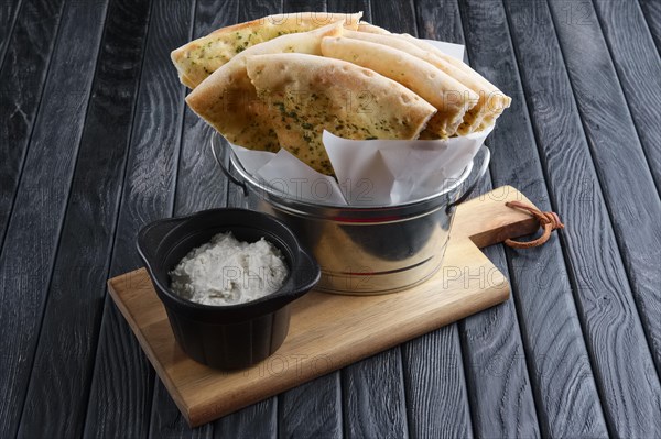 Focaccia served in metal backet with cream cheese