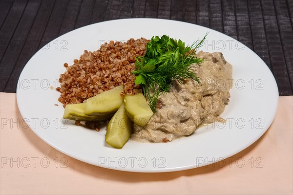 Goulash with buckwheat and pickled cucumber