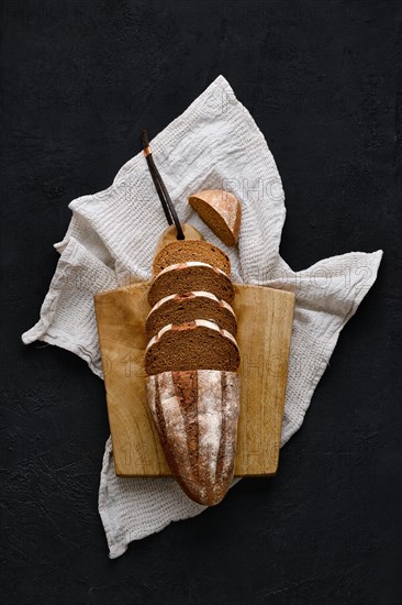 Overhead view of rue bread on dark background