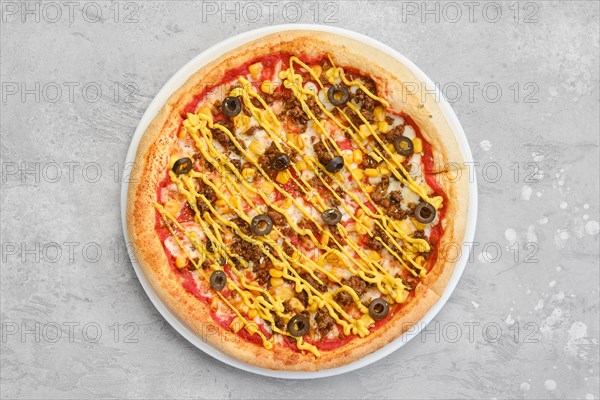 Overhead view of small size pizza with minced beef meat