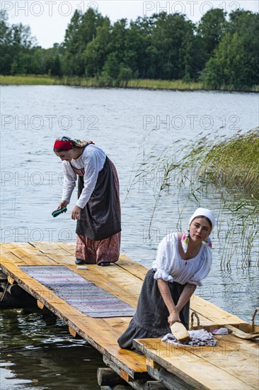 Traditionla dressed women doing hand washing