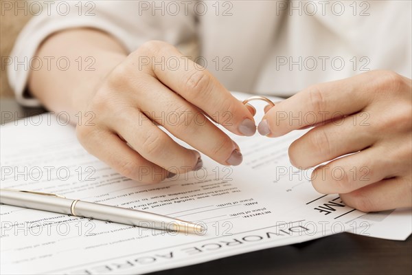 Close up hands holding wedding ring