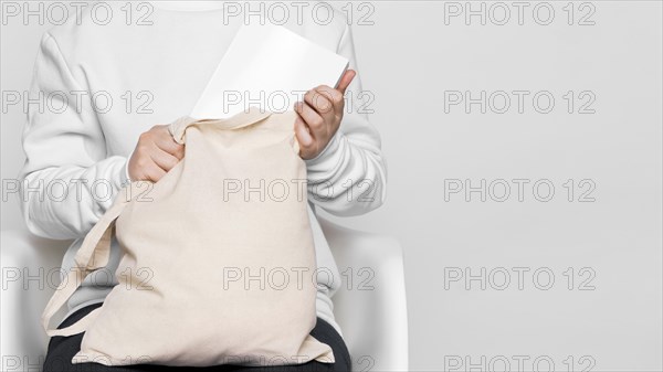 Front view woman holding fabric tote bag