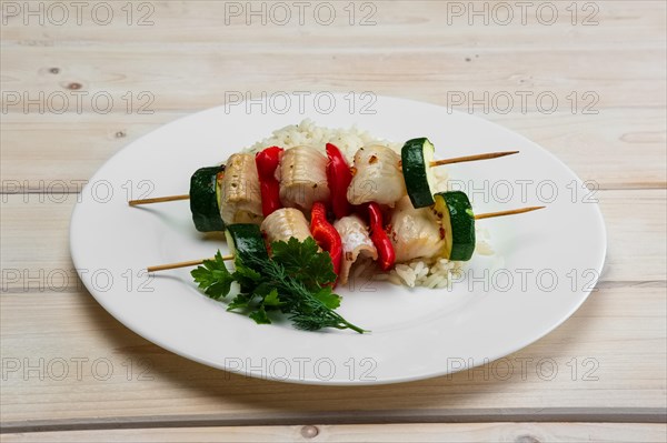 Grilled fish and vegetables on skewer with boiled rice