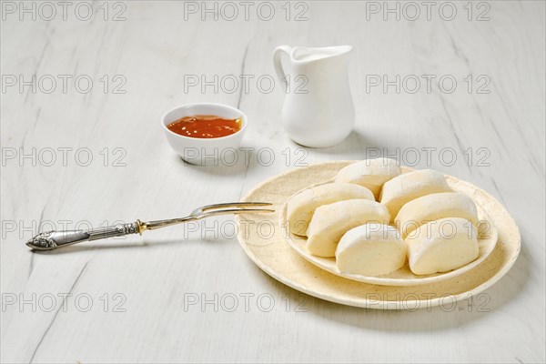 Semifinished frozen lazy dumplings made of curd on a plate