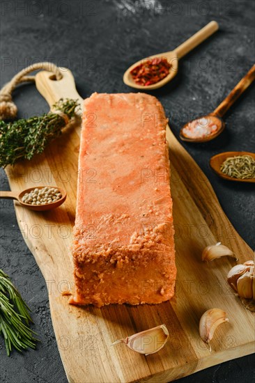 Raw pieces of salmon pressed in briquette with spice and herbs