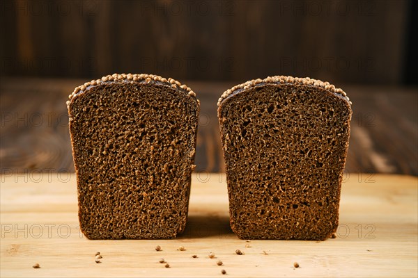 Closeup view of fresh rye brown bread on wooden cutting board