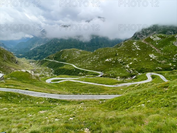 Hairpin bends with approaching weather front at Colle del Nivolet