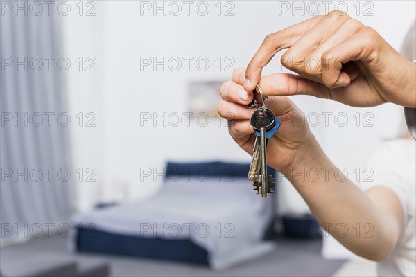 Close up couple s hand holding house keys bedroom