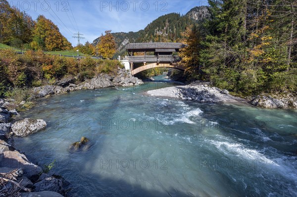 Wooden bridge over the Ostrach in the autumnal Ostrachtal