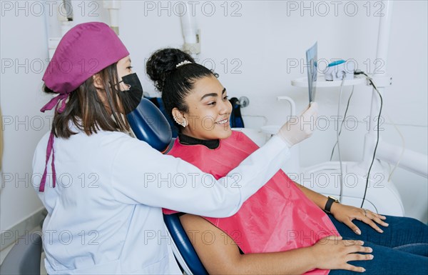 Dentist showing patient x-ray