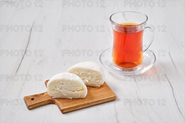 Sweet dessert mochi with coconut chips cut on half with fruit tea