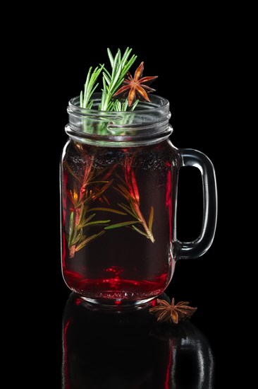 Hot cherry tea with cinnamon and rosemary in mason jar