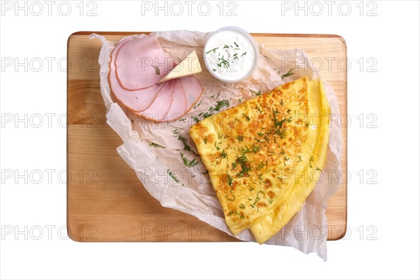 Top view of thin pancakes with ham and cheese isolated on white background