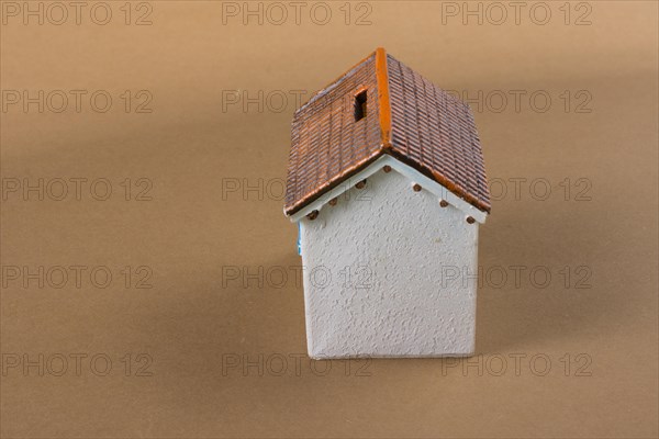Little model house on a color background in the view