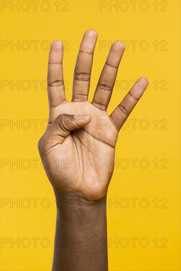 Hand showing four fingers