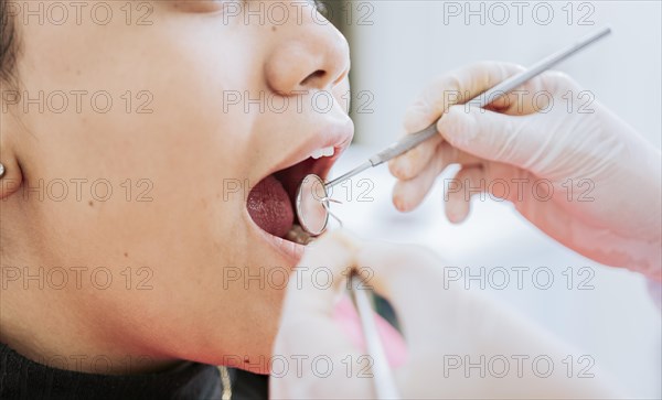 Close up of patient checked by dentist